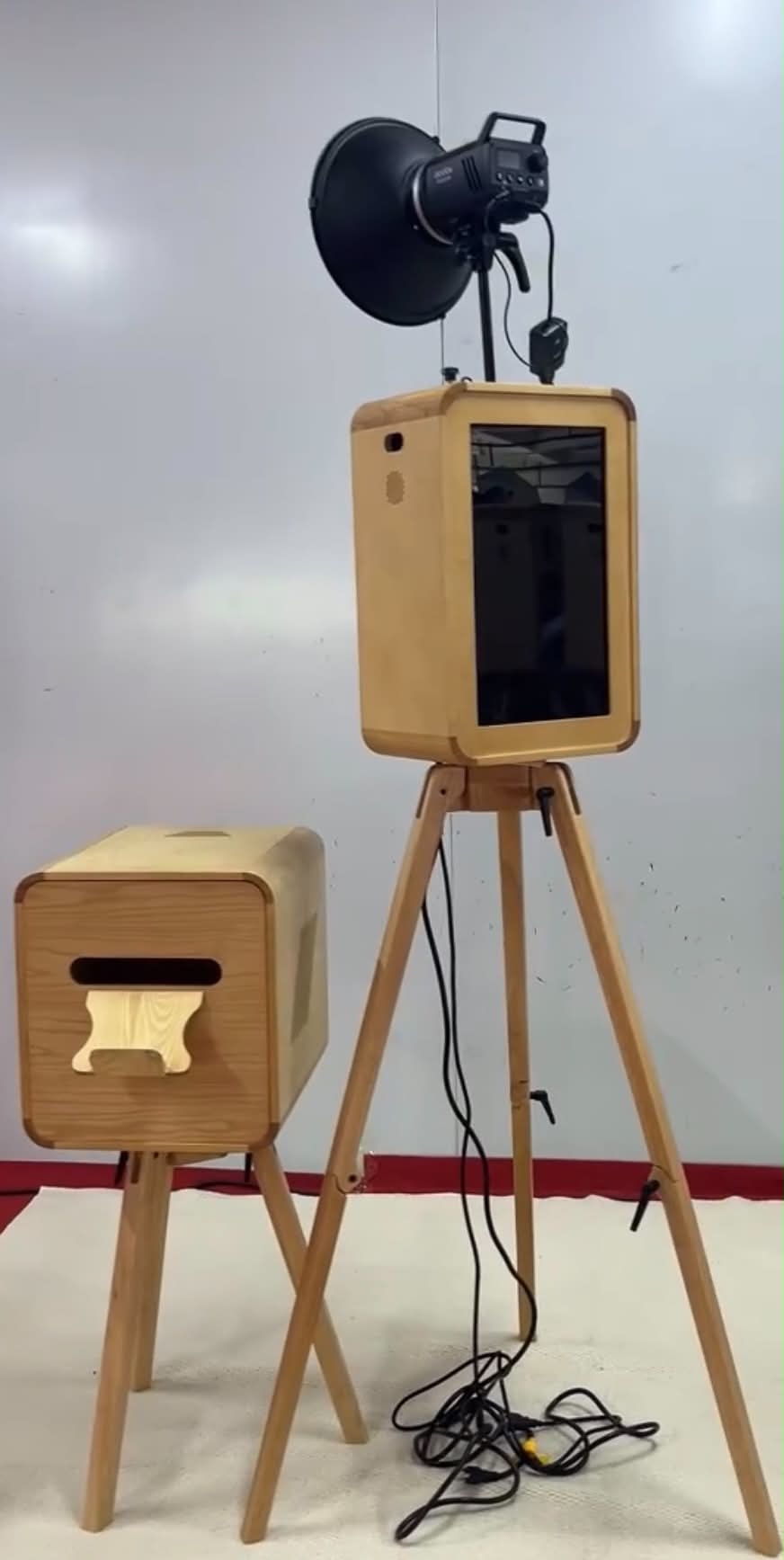 Wooden open-air photo booth kiosk with a matching instant print station